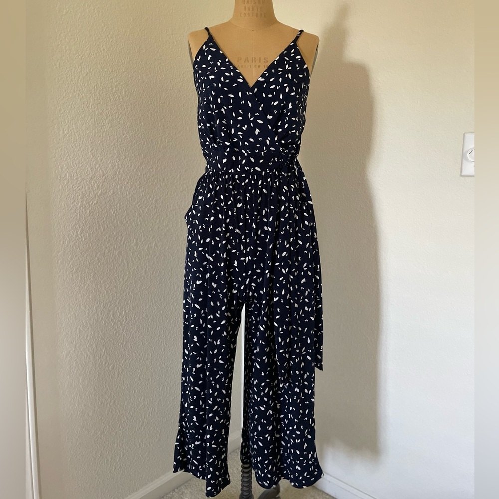 Navy blue dotted lightweight sleeveless cropped jumpsuit with tie waist. Medium
